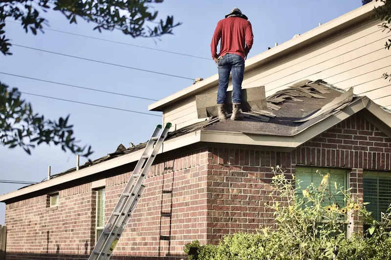Professional roofer working on a residential roof in Corsons